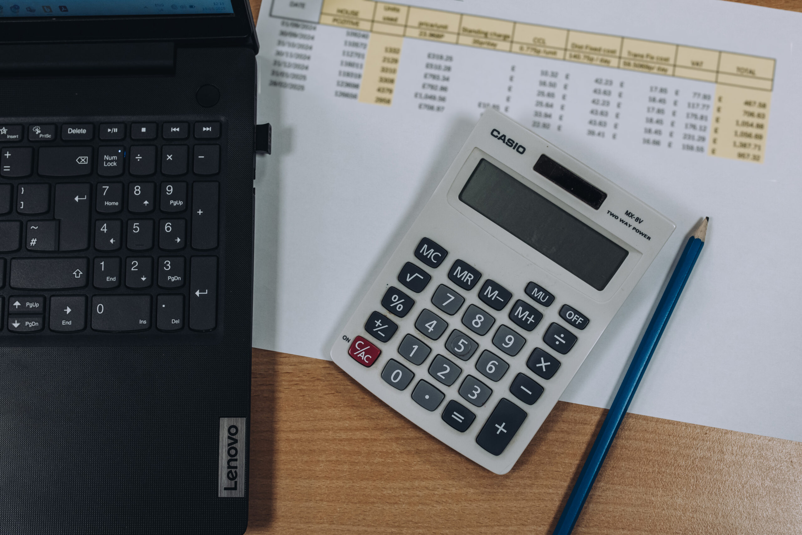 Calculator next to laptop business planning and cashflow